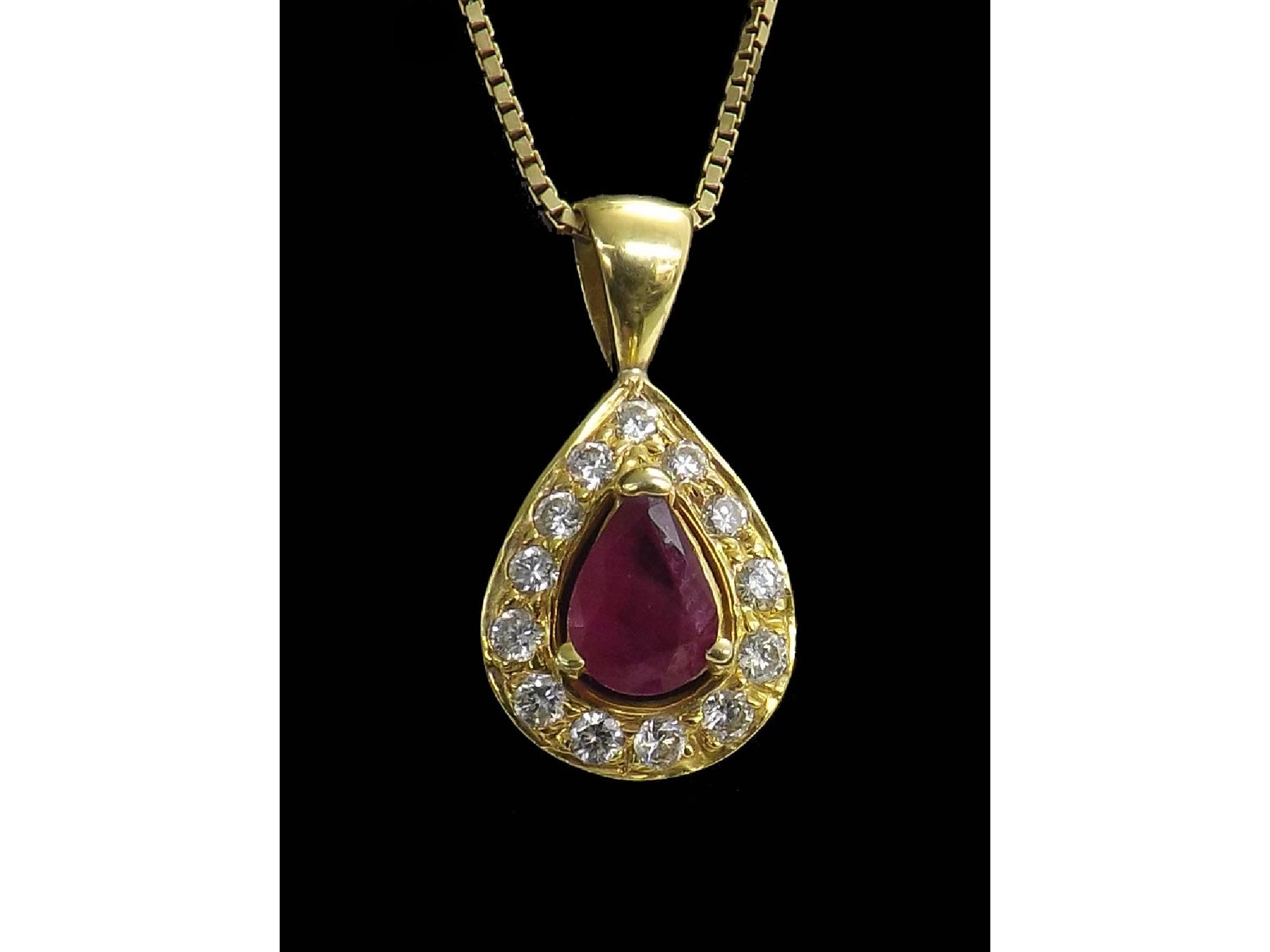 Appraisal: k ruby and diamond pear shaped pendant on a slender