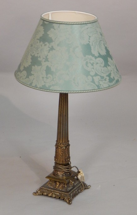 Appraisal: A gilt metal column table lamp decorated with leaves masks