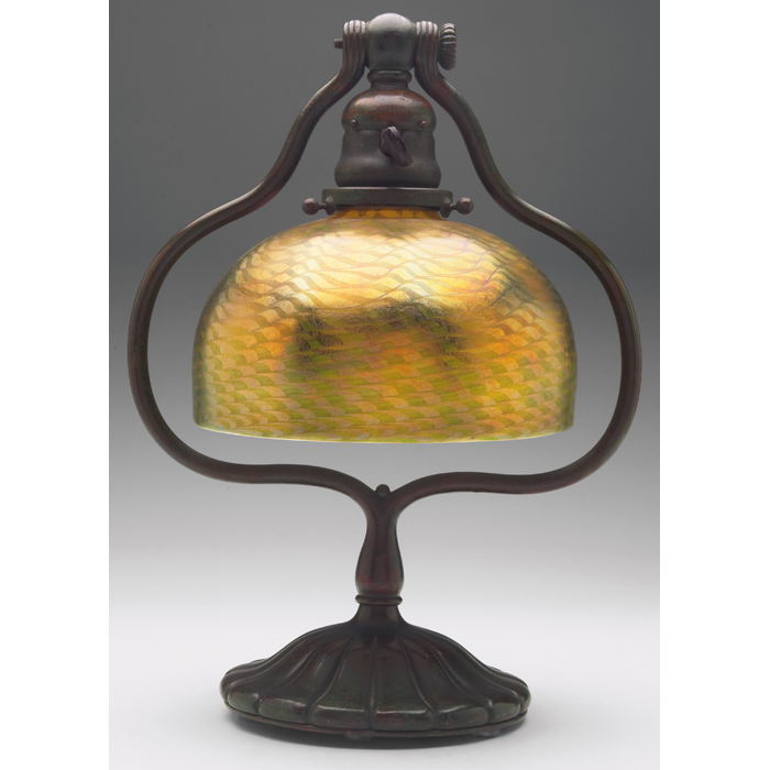 Appraisal: Tiffany Studios desk lamp bronze baseholding a favrile glass shade