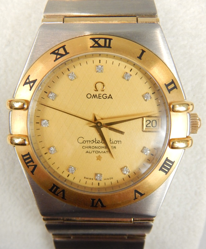 Appraisal: A Omega Constellation model bi-coloured wristwatch having textured beige dial