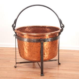 Appraisal: Large copper cauldron on wrought iron stand Large copper cauldron