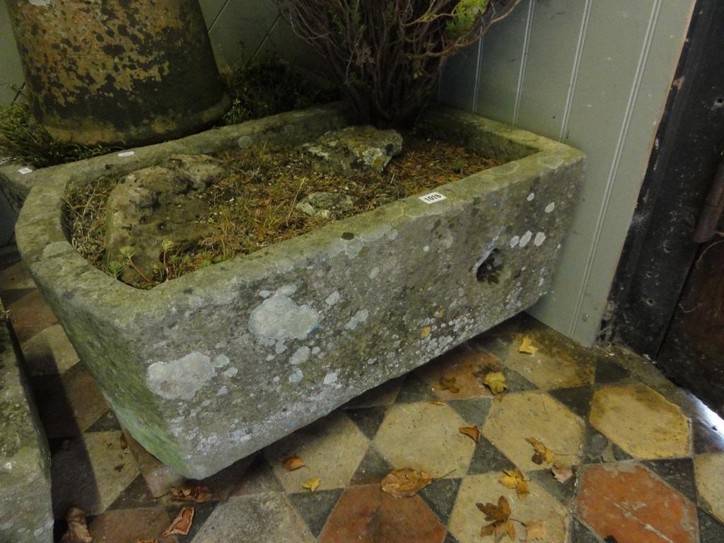 Appraisal: A weathered natural stone garden trough of rectangular form with