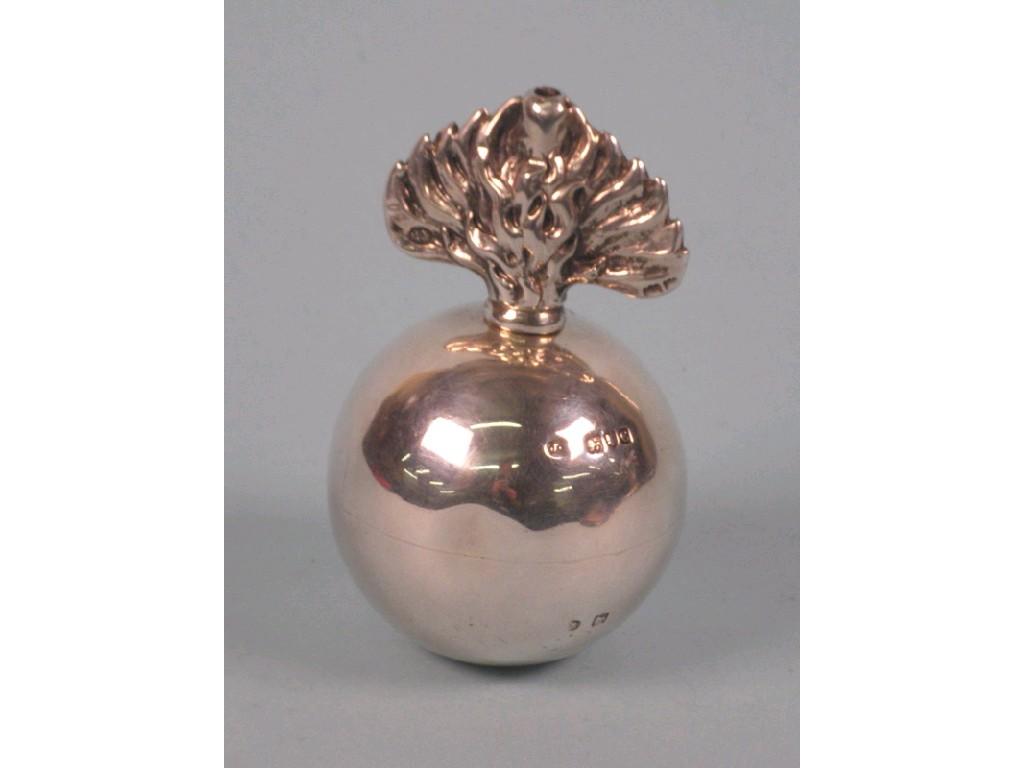 Appraisal: A silver circular table lighter with a stylised flame finial