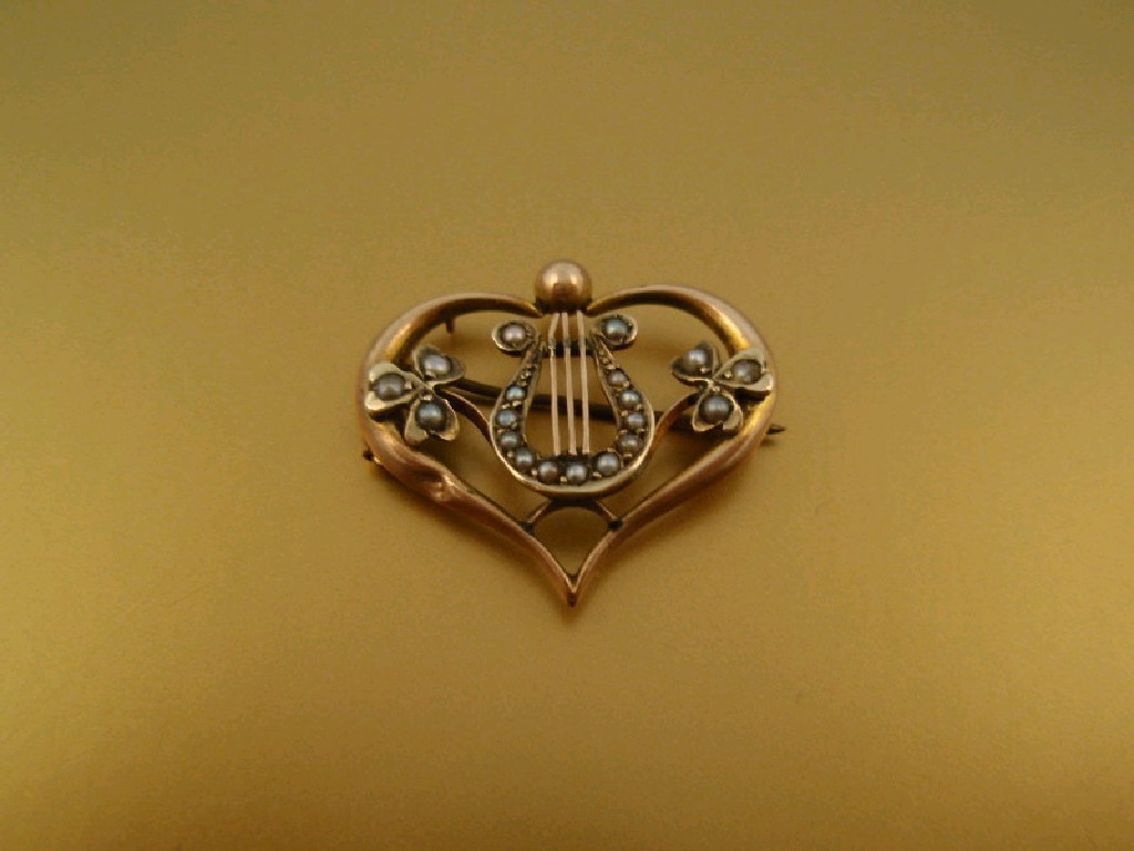 Appraisal: An Edwardian seed pearl set brooch heart shape with lyre