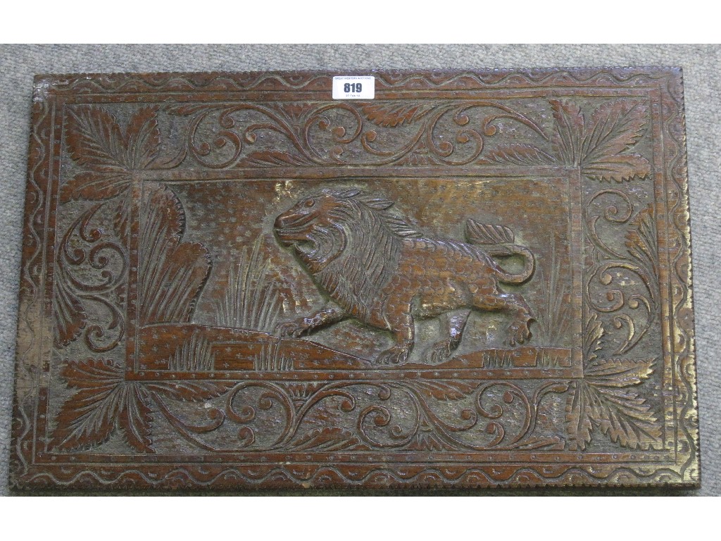 Appraisal: Carved hardwood panel depicting a lion in a forest