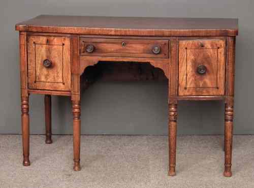 Appraisal: A George IV figured mahogany bow-front sideboard with crossbanded top