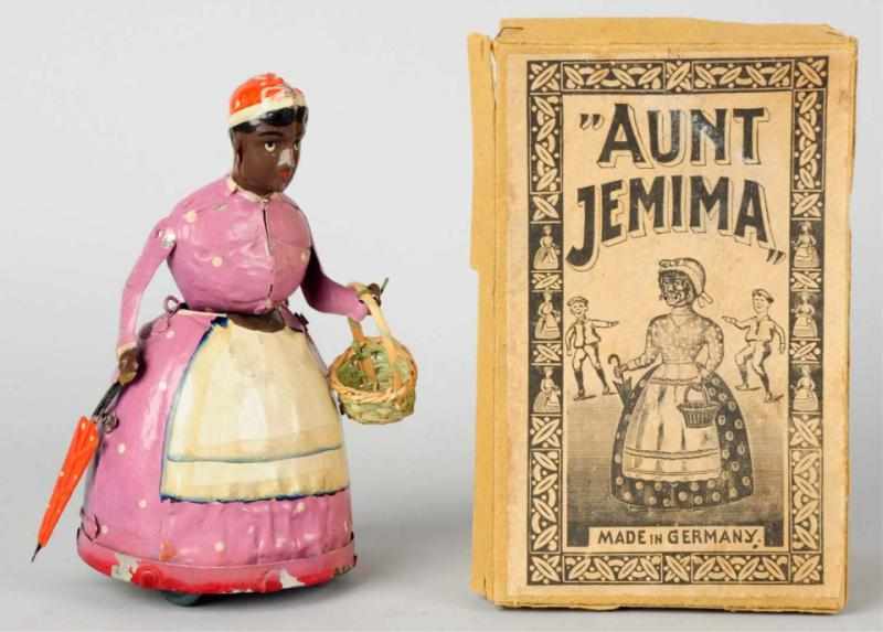 Appraisal: Hand-Painted Tin Aunt Jemima Wind-Up Toy German Working Marked Made