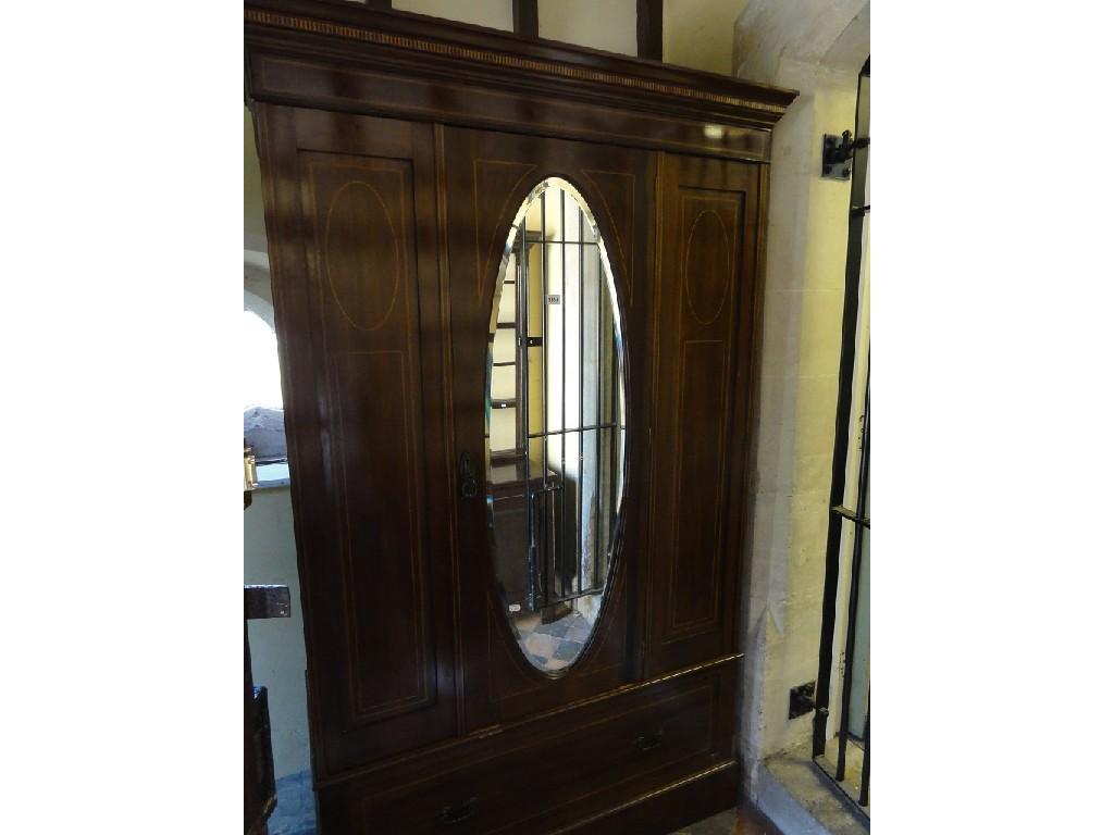 Appraisal: An inlaid Edwardian mahogany wardrobe with box wood stringing and