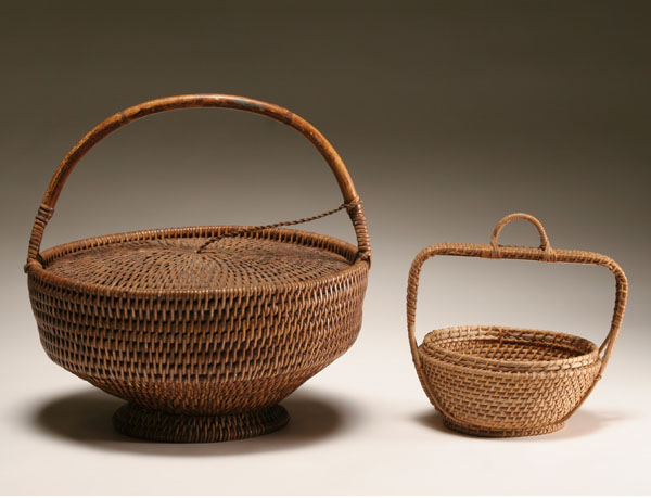 Appraisal: Two vintage tightly woven work sewing handled baskets The larger