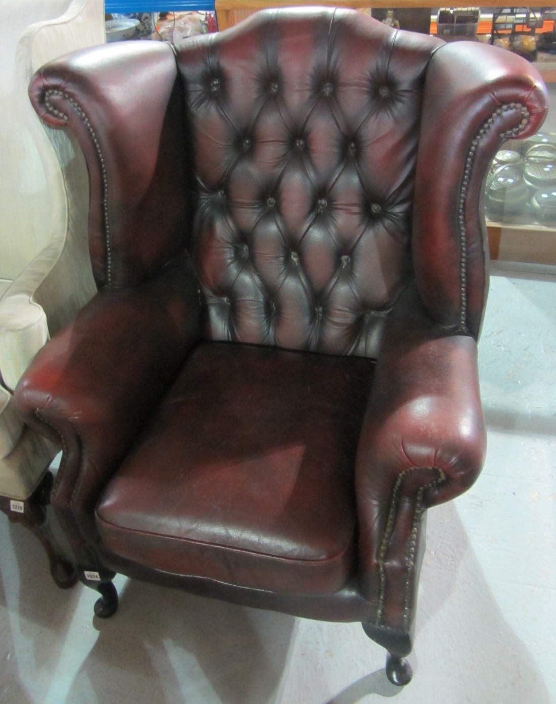 Appraisal: A th century red leather button back wing armchair