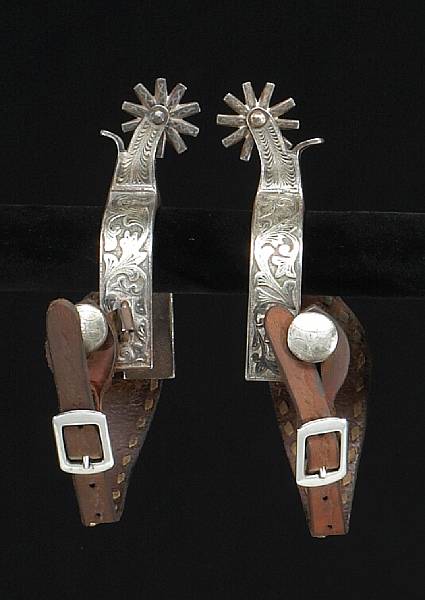 Appraisal: A pair of unmarked double-mounted western spurs Heel bands with