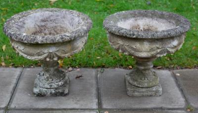 Appraisal: A pair of reconstituted stone garden vases with flanged egg