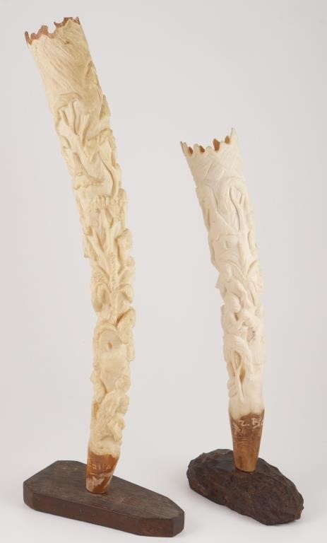 Appraisal: Pair of carved African ivory tusks showing multiple figures Each