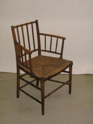 Appraisal: AN ARTS AND CRAFTS ASH SUSSEX ARM CHAIR the turned