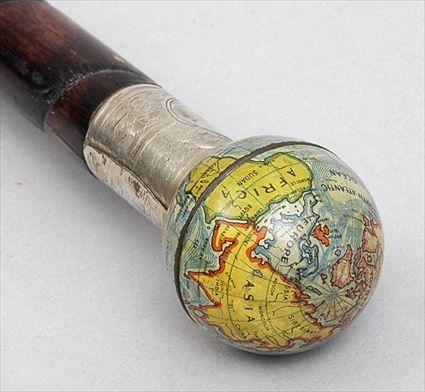 Appraisal: STAINED BAMBOO CANE WITH TERRESTRIAL GLOBE HANDLE The painted metal