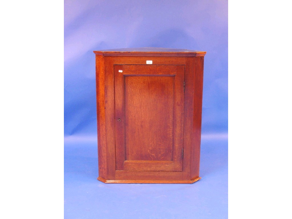 Appraisal: A Georgian oak hanging corner cupboard cm high