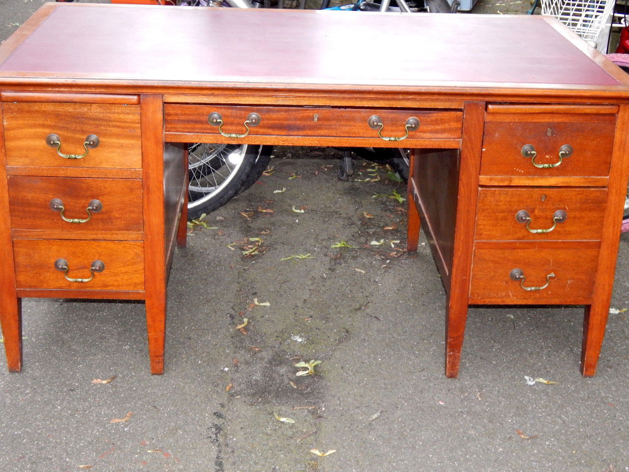 Appraisal: An oak and mahogany twin pedestal desk with one long