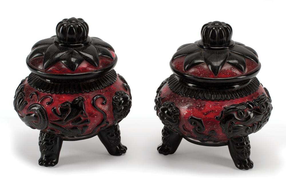 Appraisal: Pair of Chinese Black Overlay Amber Glass Covered Tripod Censers