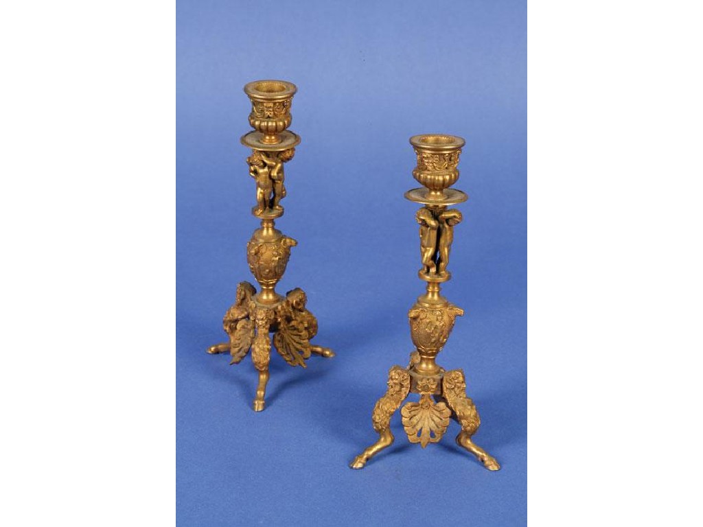 Appraisal: A PAIR OF RENAISSANCE REVIVAL GILT METAL CANDLESTICKS with vase