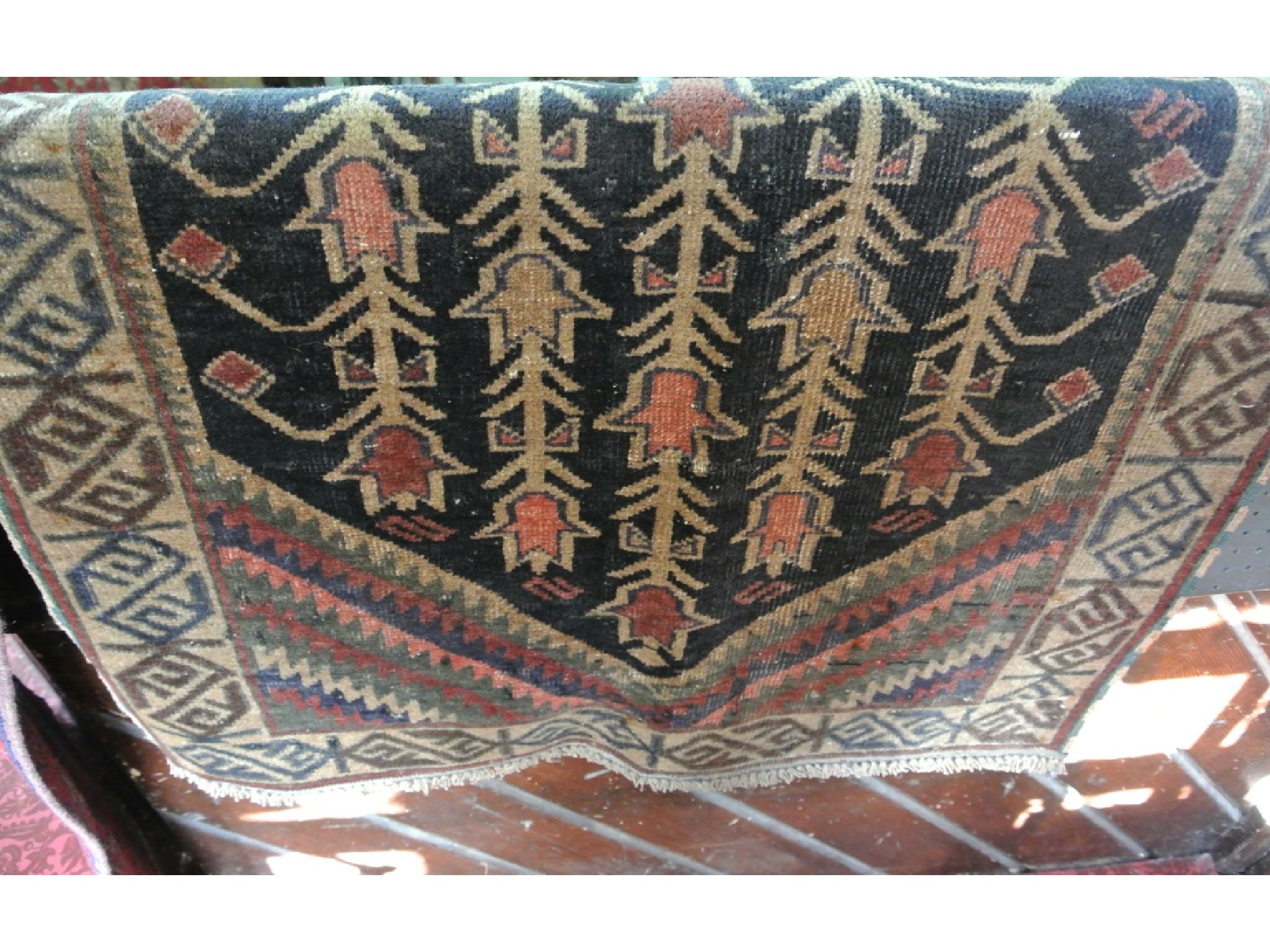 Appraisal: An Eastern wool rug with abstract detail upon a dark