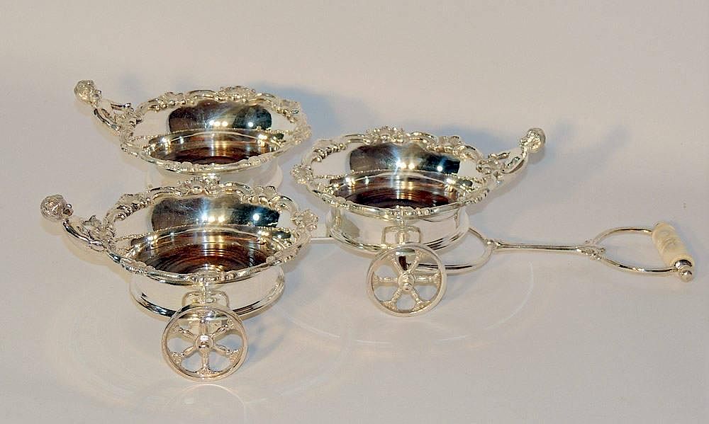 Appraisal: Silver Plated Triple Wine Trolley With wooden coasters and shell-form