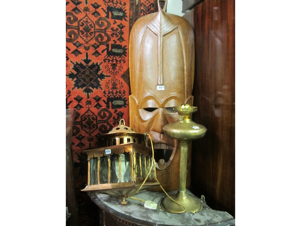 Appraisal: Brass oil lamp copper ceiling light and African wall mask