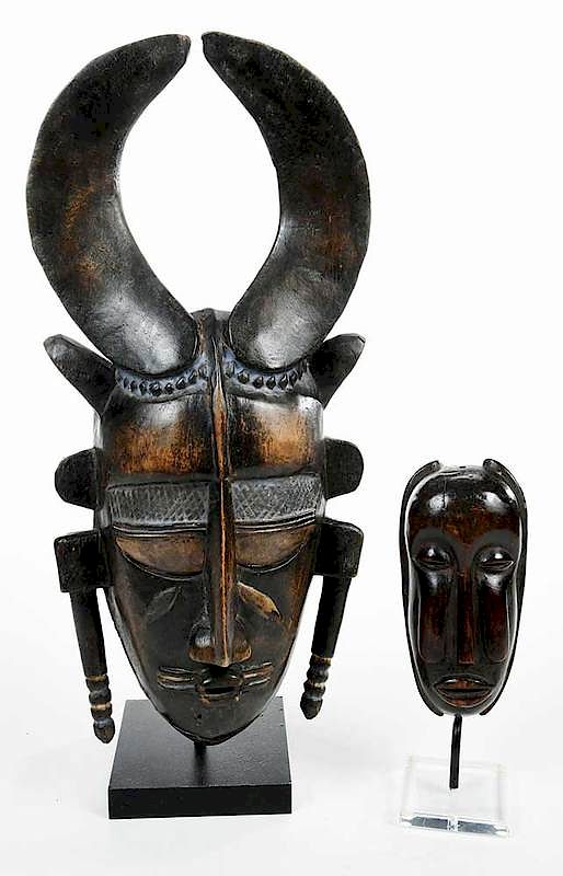 Appraisal: Two Carved Wood African Masks Mounted comprising one with elongated