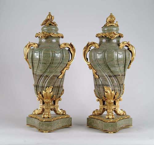 Appraisal: OUTSTANDING PAIR OF GREEN MARBLE AND ORMOLU CASSOLETS Sculptured urn