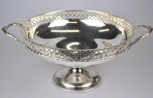 Appraisal: A two-handled fruit bowl with pierced rim on stemmed foot