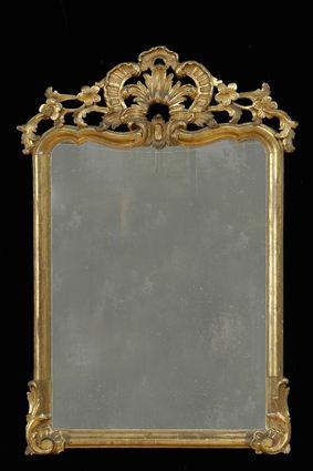 Appraisal: ROCOCO-STYLE CARVED GILTWOOD MIRROR The molded frame with pierced crest