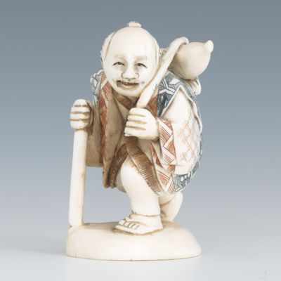 Appraisal: A Carved Ivory Netsuke of a Traveler Carved ivory netsuke