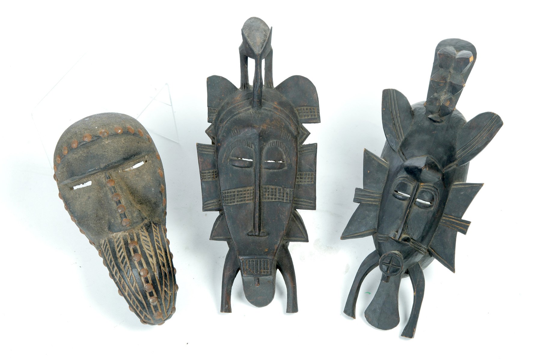 Appraisal: THREE AFRICAN CARVED WOOD MASKS Mid th century Two Senufo