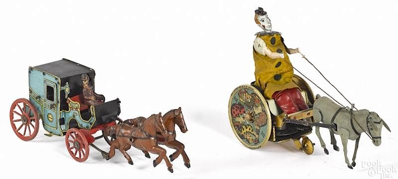 Appraisal: Two tin wind-up toys Two tin wind-up toys to include