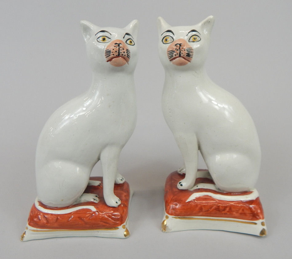 Appraisal: A pair of thC Staffordshire pottery cats each seated on