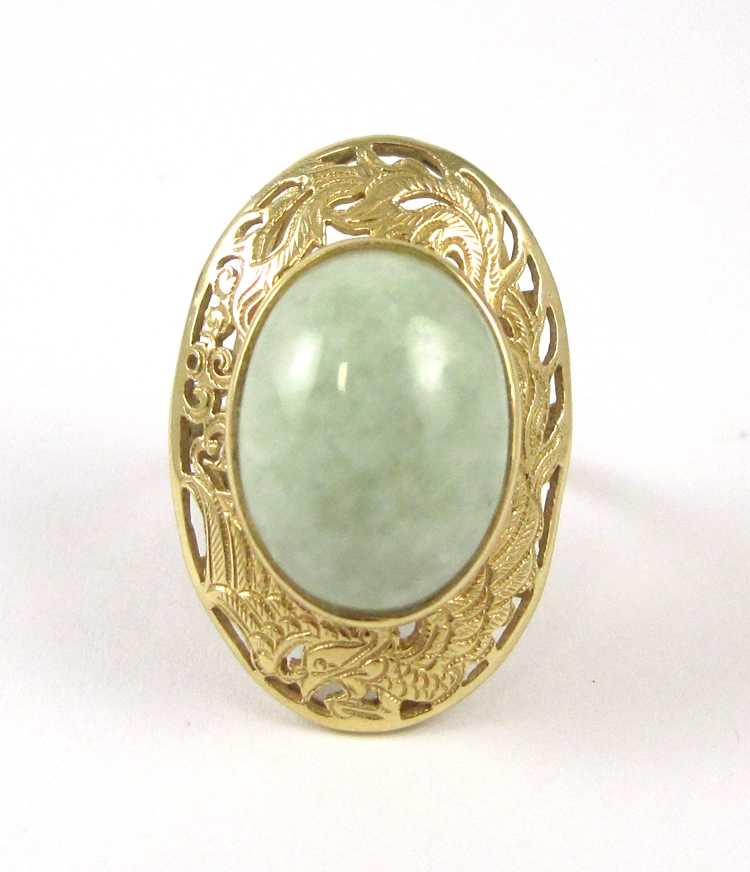 Appraisal: JADE AND FOURTEEN KARAT GOLD RING bezel set with an