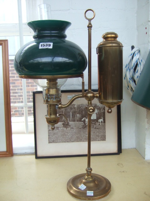 Appraisal: A Victorian brass adjustable table oil lamp with green glass