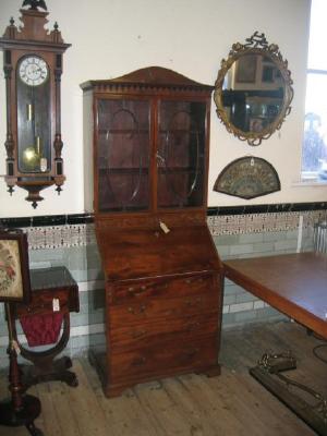 Appraisal: A MAHOGANY BUREAU BOOKCASE the lambrequin cornice with arched surmount