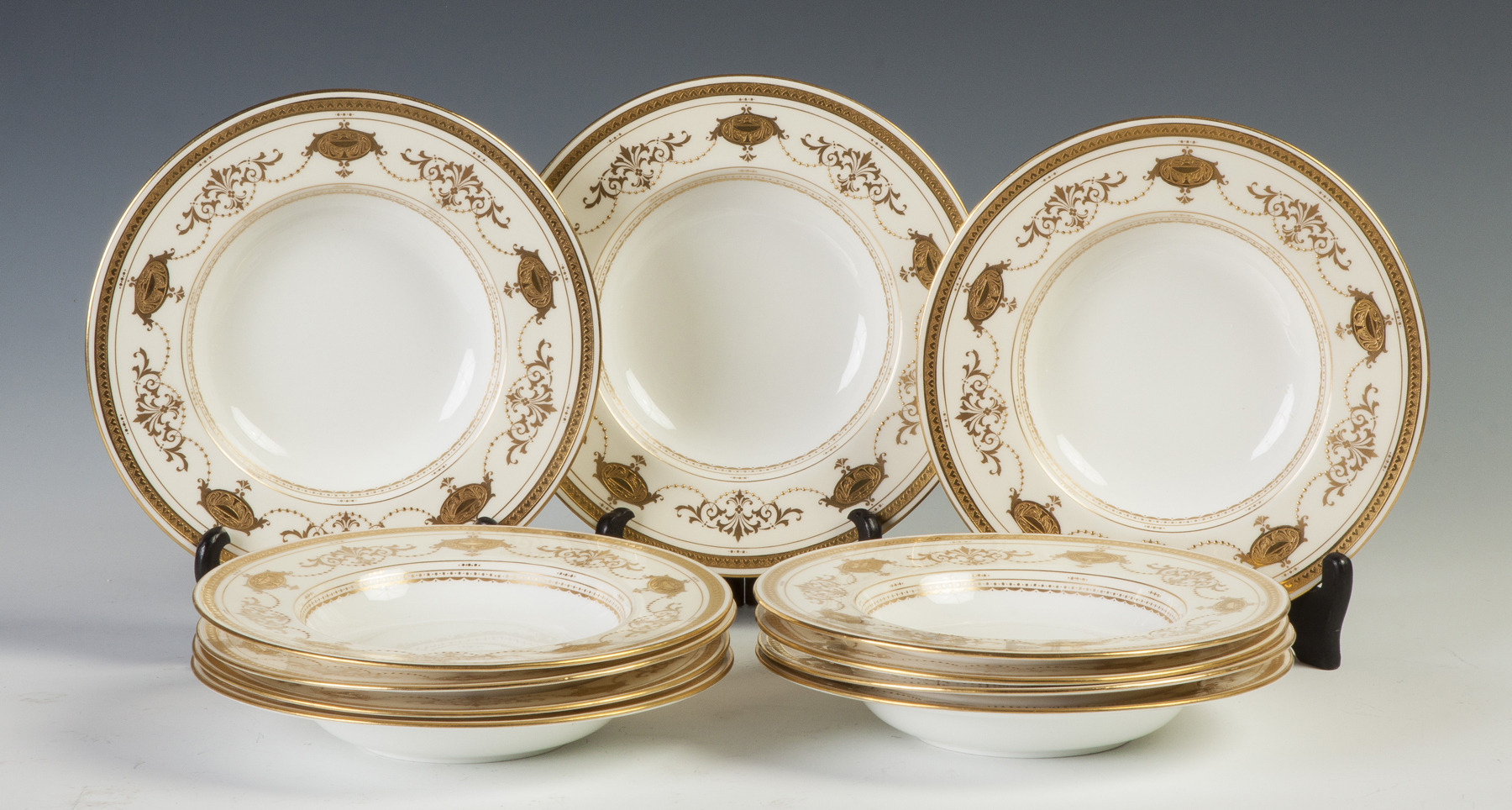 Appraisal: Set of Minton Soup Bowls Dinner Plates Gold enameled design