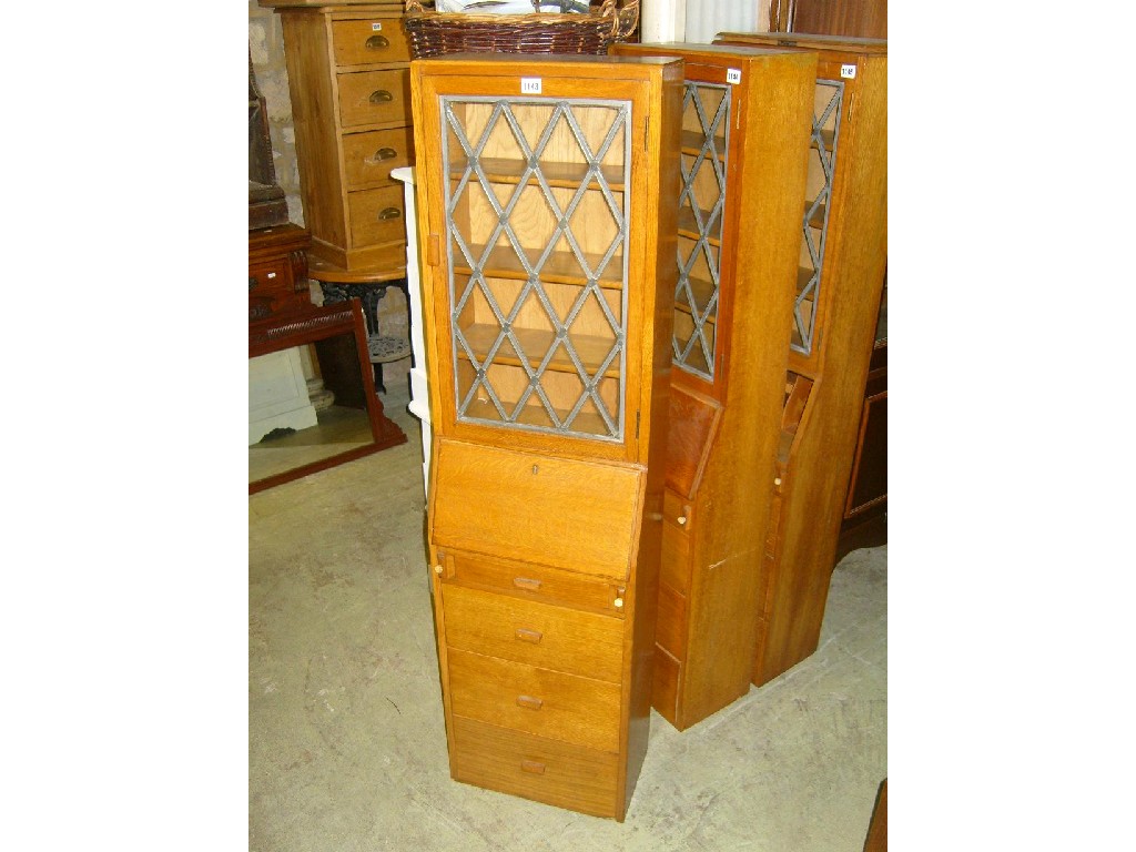 Appraisal: A light oak upright bureau bookcase of slim form the