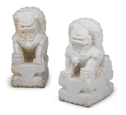 Appraisal: Pair of white stone fu lionsEach modeled seated one paw