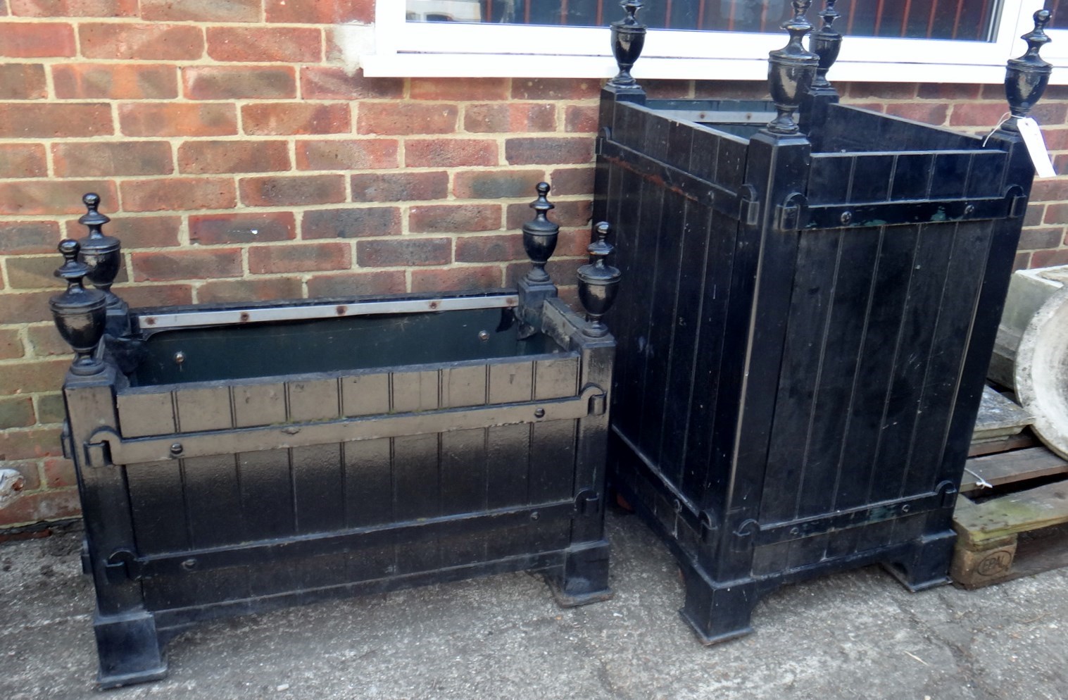 Appraisal: Two iron bound black painted rectangular planters with urn finials