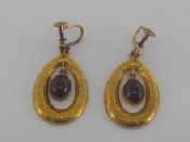 Appraisal: A pair of carat gold and garnet earrings of wreath