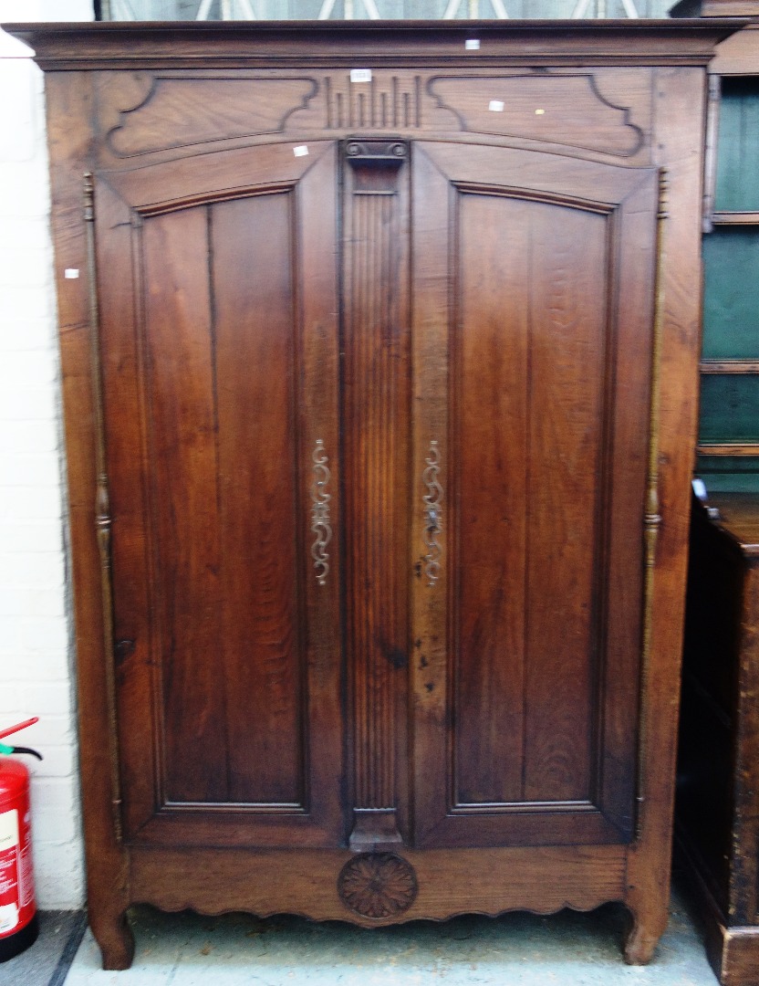 Appraisal: An th century French chestnut two door armoire on shaped