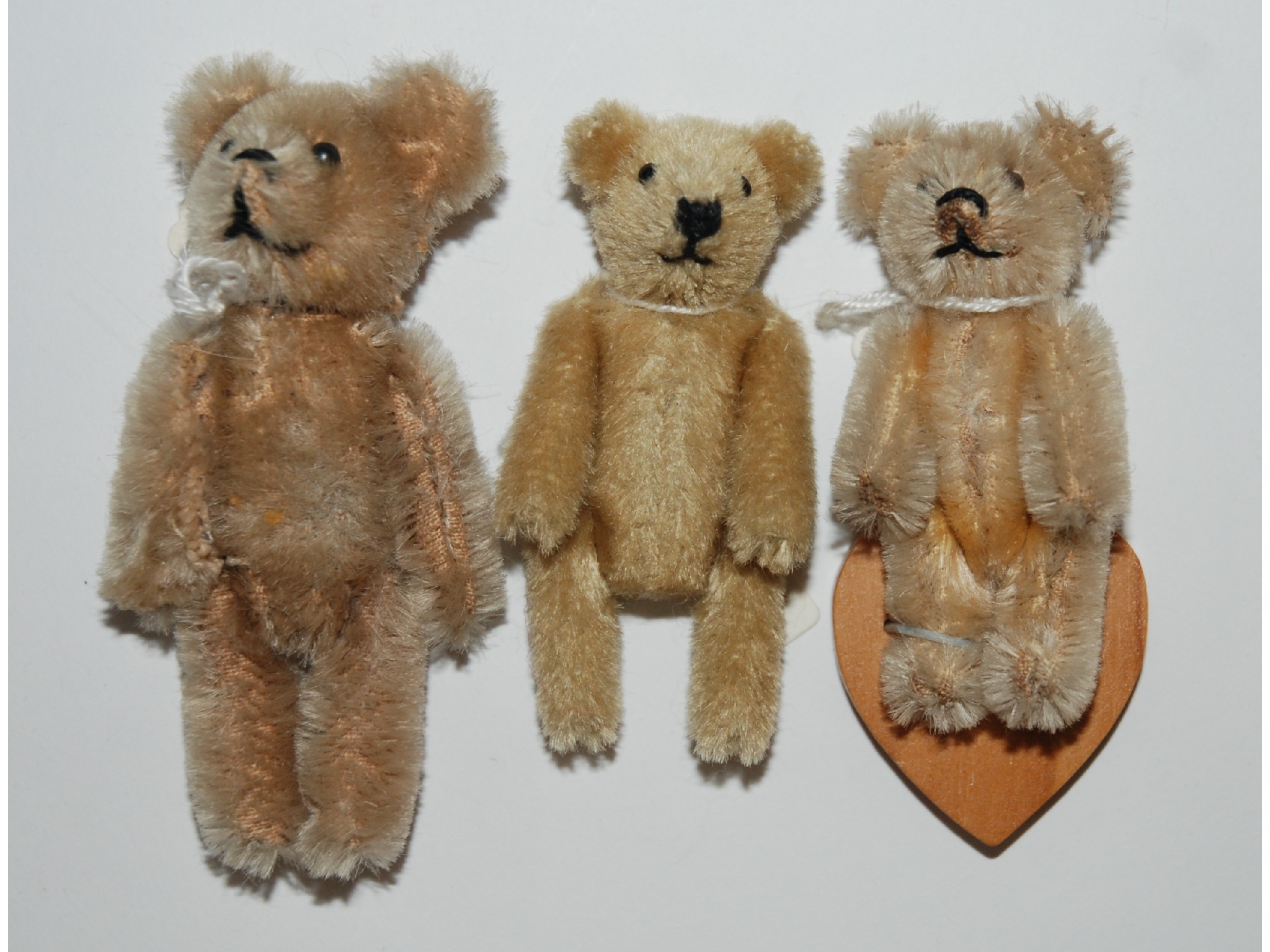 Appraisal: Three miniature Schuco Teddy Bearswith fawn plush bodies swivel heads