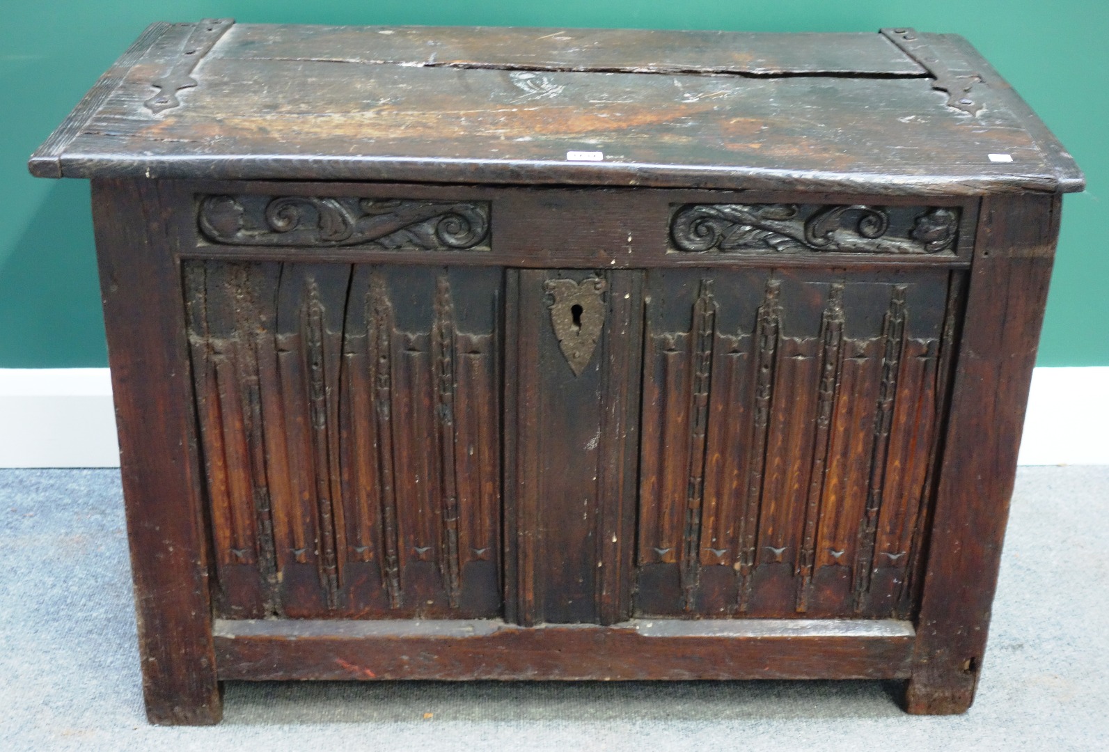 Appraisal: An early th century carved oak coffer with double linen