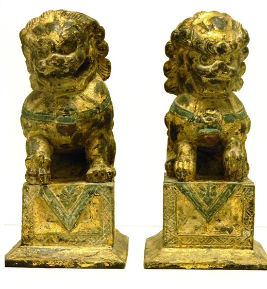 Appraisal: Pair of carved wooden Foo lions gilt and green decoration