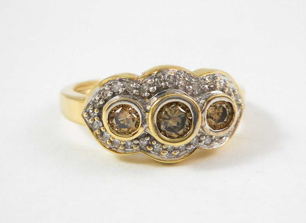 Appraisal: CHAMPAGNE DIAMOND AND TEN KARAT GOLD RING The yellow and