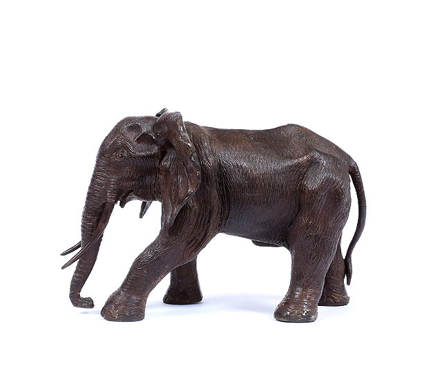 Appraisal: A BRONZE SCULPTURE OF AN ELEPHANT cm long trunk to