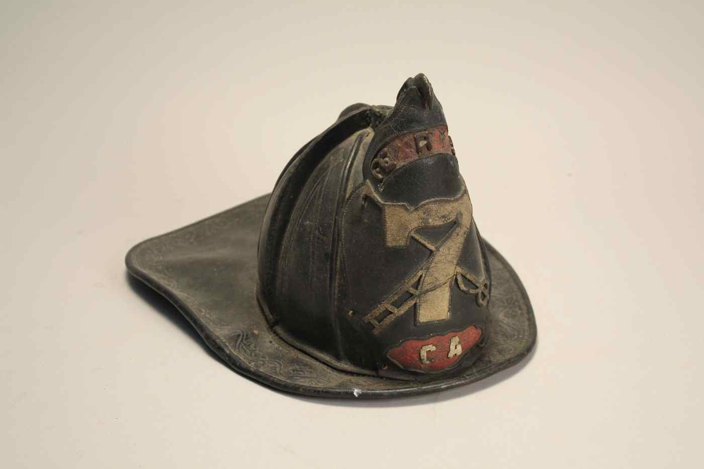 Appraisal: LEATHER FIRE HELMET th CenturyWith brass eagle Marked CA'' ''