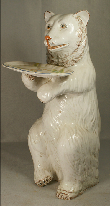 Appraisal: Tin glazed standing bear holding a tin glazed oval scalloped